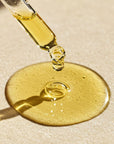 Gold dropper bottle with liquid, Argan and almond hair repair oil to restore shine, smooth frizz and strengthen damaged hair. Award-winning hair growth products for scalp care and hair wellness