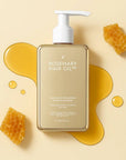 Rosemary Hair Oil Co. shampoo bottle with honeycomb and honey on a beige background. Nourishing hair growth shampoo designed to reduce breakage and support longer hair