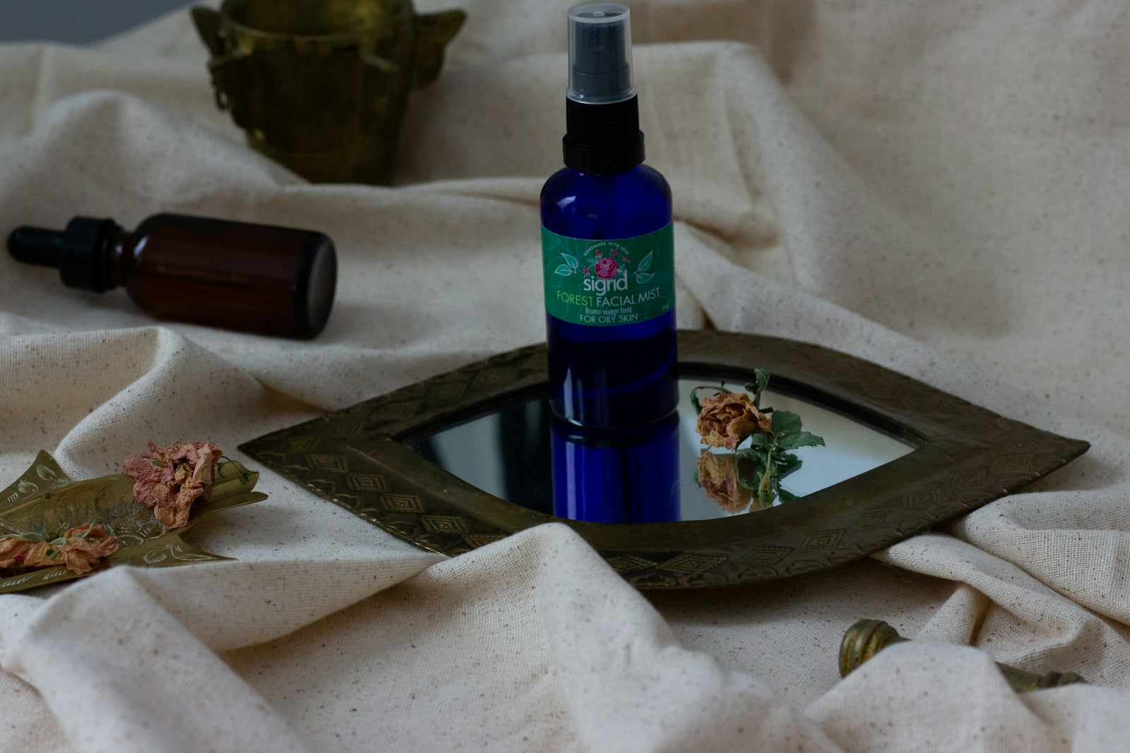 a bottle of lotion sitting on top of a mirror