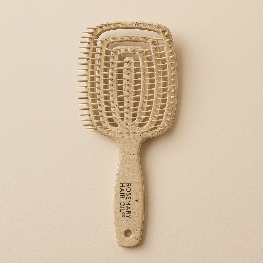 Beige hairbrush with 'Rosemary Hair Oil Co.' branding on a beige background, detangle brush, tangle teaser, flexi brush