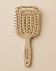 Beige hairbrush with 'Rosemary Hair Oil Co.' branding on a beige background, detangle brush, tangle teaser, flexi brush
