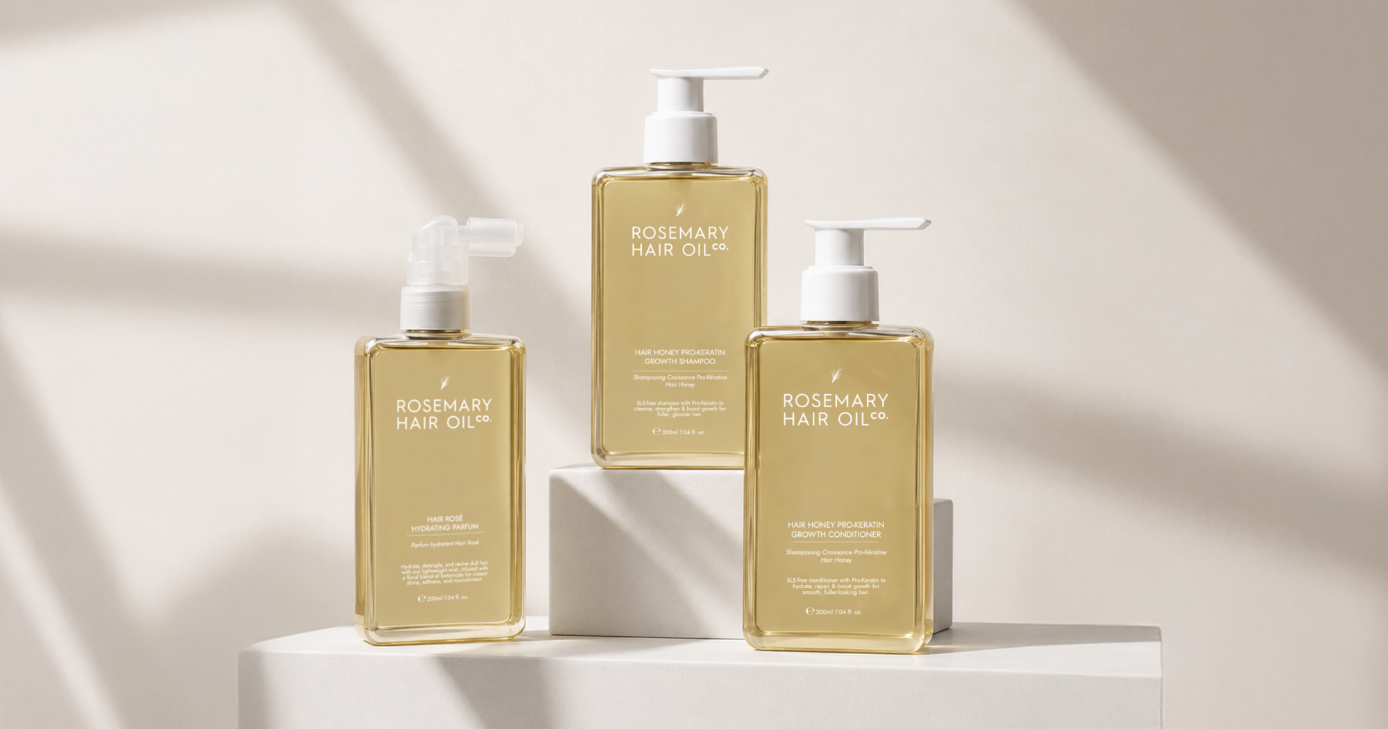 Three bottles of Rosemary Hair Oil Co. hair oil on a beige surface with a towel. Hair Honey Pro-Keratin Growth Shampoo. Hair Honey Pro-Keratin Growth Conditioner. Hair Rosé Hydrating Parfum Three bottles of Rosemary Hair Oil on a beige surface with a beige background. Hair Honey Pro-Keratin Growth Shampoo and Conditioner for healthy hair and scalp care

Nourishing hair care routine with pro-keratin shampoo and conditioner

Hair strengthening shampoo and conditioner for fuller healthier-looking hair