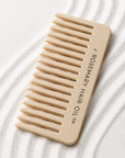 Beige comb with 'Rosemary Hair Oil Co.' branding on a beige background, wide tooth flat comb, 
