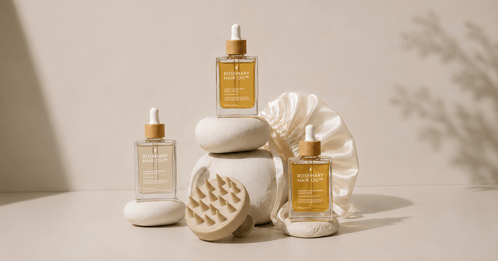 Rosemary Hair Oil Co. natural hair growth oils with scalp massager and satin bonnet for a healthy hair care routine. Rosemary hair oil intense growth syrup, caster and camellia root renewal hair oil, argan almond bond boost hair oil, scalp massager, silk hair bonnet hair halo 